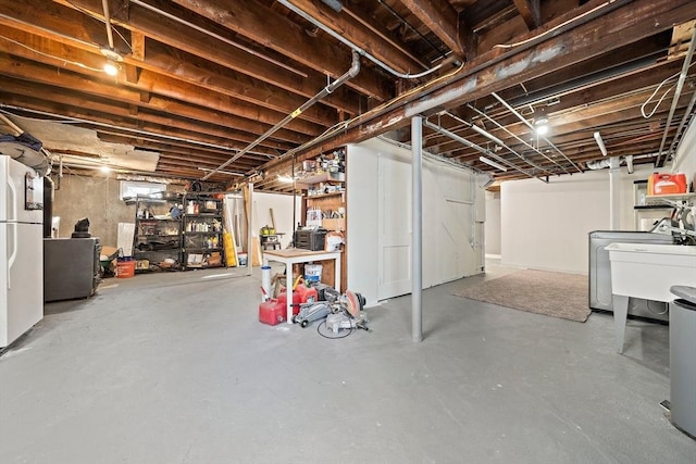 359 Corey St, Boston, MA 02132 - unfinished below grade area with freestanding refrigerator, washer / dryer, and a sink