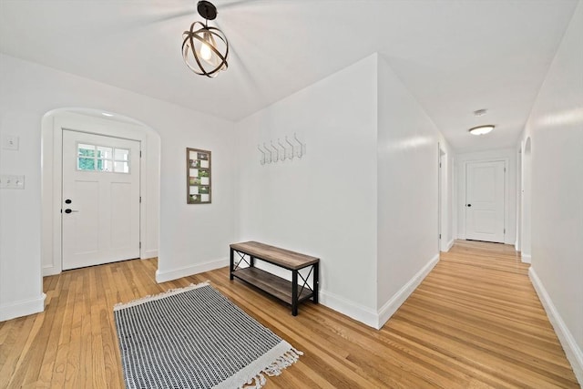 359 Corey St, Boston, MA 02132 - entrance foyer featuring light wood-type flooring, arched walkways, and baseboards