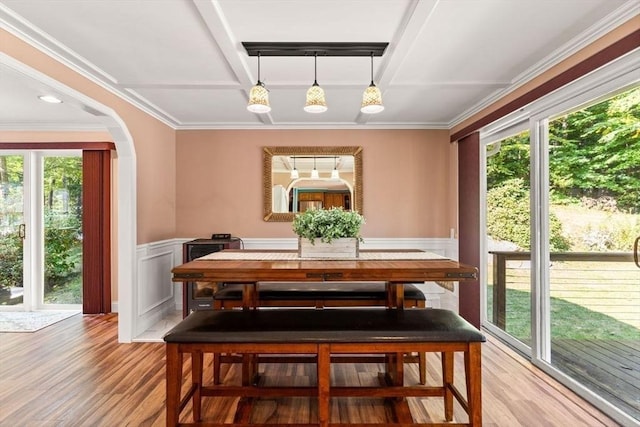5 Plouff Ln, Exeter, NH 03833 - dining space with light wood-type flooring, wainscoting, crown molding, arched walkways, and a decorative wall