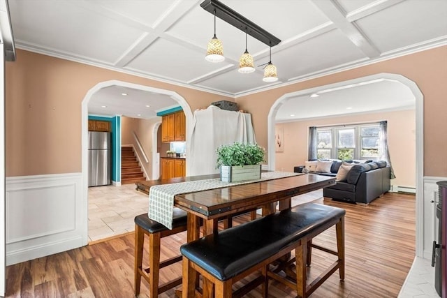 5 Plouff Ln, Exeter, NH 03833 - dining space featuring coffered ceiling, wainscoting, arched walkways, baseboard heating, and light wood-style flooring