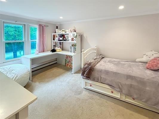 5 Plouff Ln, Exeter, NH 03833 - bedroom with a baseboard heating unit, ornamental molding, carpet, and recessed lighting