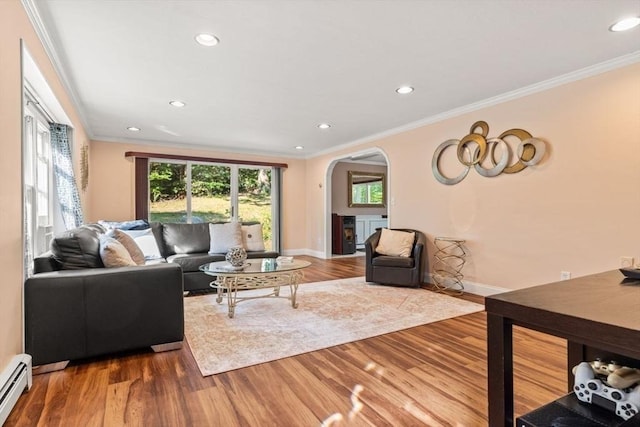 5 Plouff Ln, Exeter, NH 03833 - living area featuring arched walkways, a baseboard heating unit, ornamental molding, wood finished floors, and recessed lighting