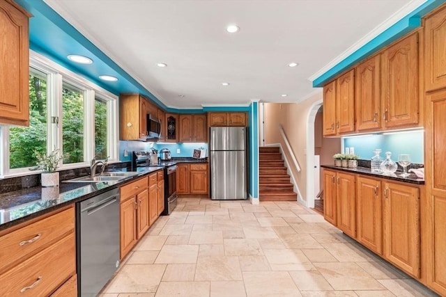 5 Plouff Ln, Exeter, NH 03833 - kitchen featuring stainless steel appliances, a sink, arched walkways, dark stone counters, and light stone finish flooring