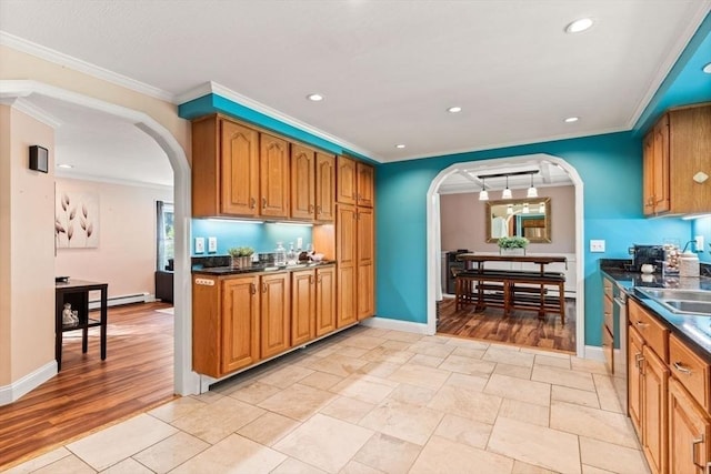 5 Plouff Ln, Exeter, NH 03833 - kitchen with arched walkways, brown cabinetry, recessed lighting, and ornamental molding