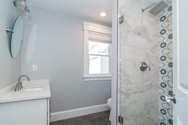 bathroom with vanity, baseboards, recessed lighting, a stall shower, and toilet