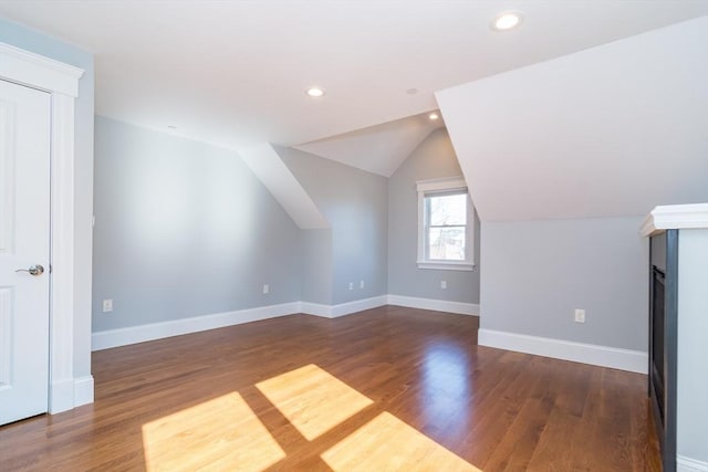 bonus room with vaulted ceiling, recessed lighting, baseboards, and wood finished floors