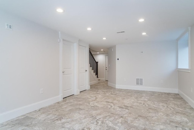 spare room with recessed lighting, visible vents, baseboards, and stairs