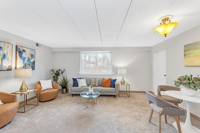 carpeted living area with baseboards and visible vents