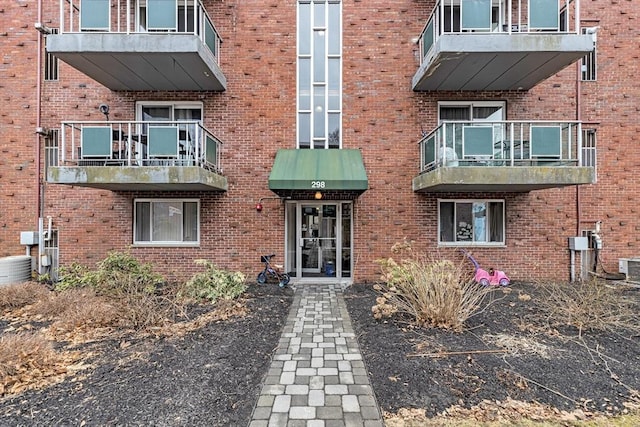 exterior space with brick siding and central air condition unit