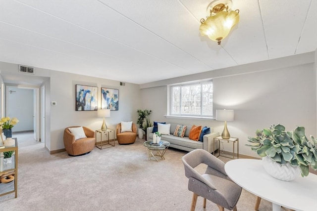 living room featuring carpet, visible vents, and baseboards