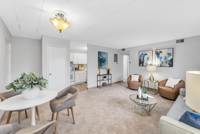 living room featuring baseboards, visible vents, and light colored carpet