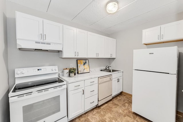 kitchen with white appliances, under cabinet range hood, white cabinets, and a sink