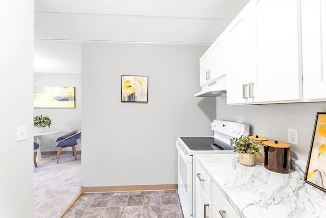 kitchen featuring light stone counters, under cabinet range hood, white cabinetry, and electric range