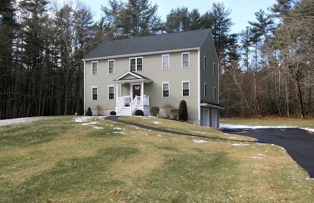 colonial house with a garage and a front yard