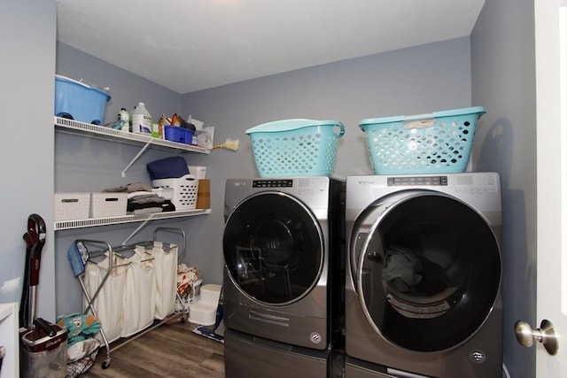 laundry room featuring dark wood-type flooring and washer and clothes dryer