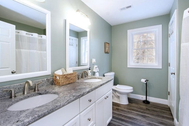 bathroom with vanity, hardwood / wood-style floors, and toilet