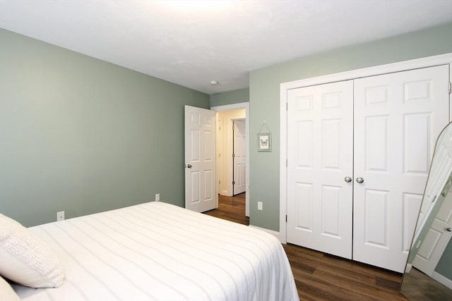 bedroom featuring dark hardwood / wood-style flooring and a closet