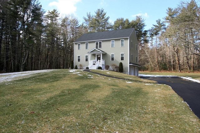 view of front of property with a garage and a front lawn