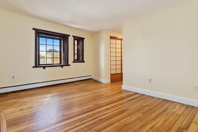 spare room featuring light hardwood / wood-style floors and a baseboard radiator