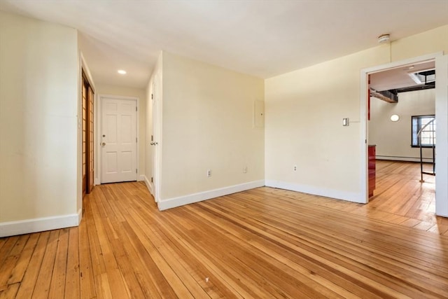 spare room featuring light hardwood / wood-style floors and baseboard heating