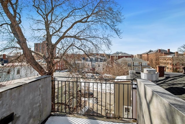 view of snow covered back of property