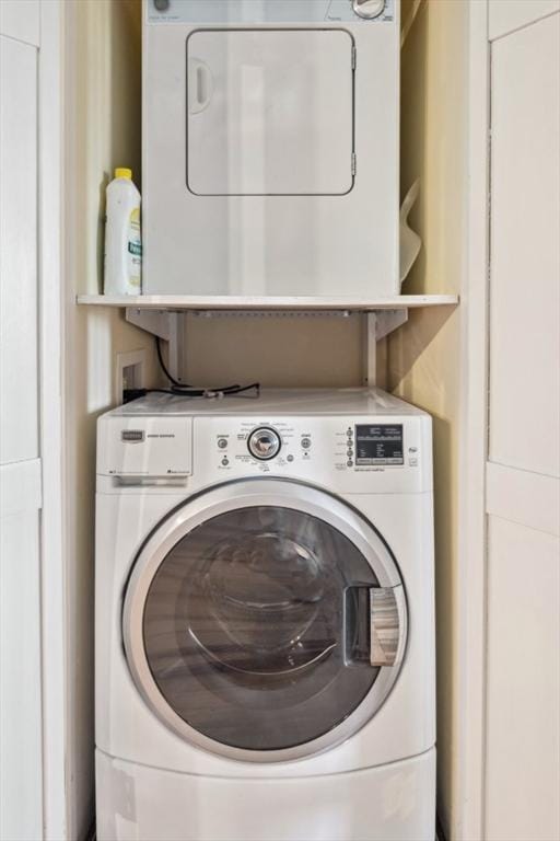 laundry area with stacked washer and dryer