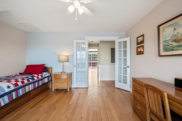 bedroom featuring light wood finished floors, french doors, and visible vents