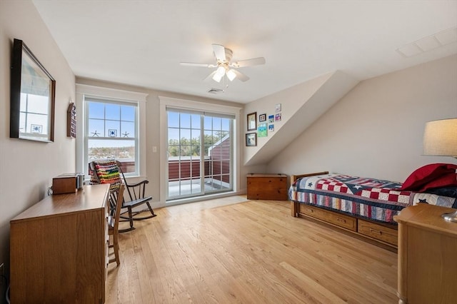 bedroom with access to exterior, visible vents, ceiling fan, and wood finished floors