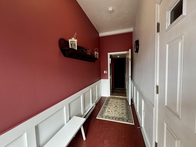 hall with a decorative wall and wainscoting