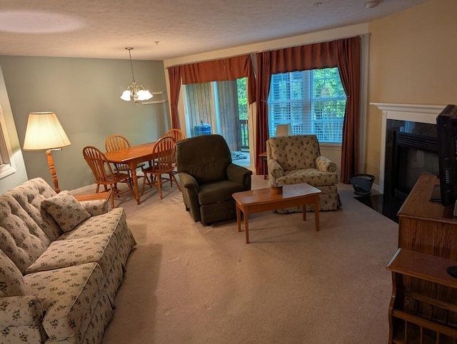 239 Bridle Cross Rd Unit 239, Fitchburg, MA 01420 - living area with a chandelier, light colored carpet, and a premium fireplace