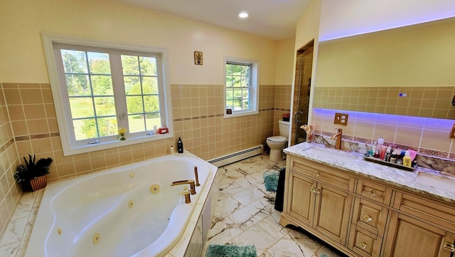 bathroom with tile walls, a bath, baseboard heating, vanity, and toilet