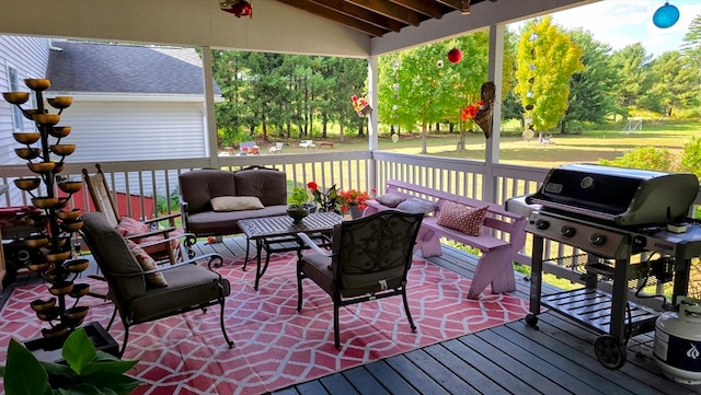 wooden deck with an outdoor hangout area and area for grilling