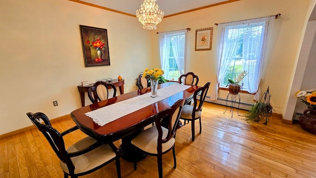 dining space with an inviting chandelier, light hardwood / wood-style flooring, baseboard heating, and ornamental molding