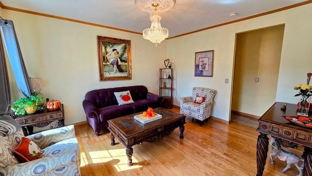 living room with light hardwood / wood-style floors, ornamental molding, and a chandelier