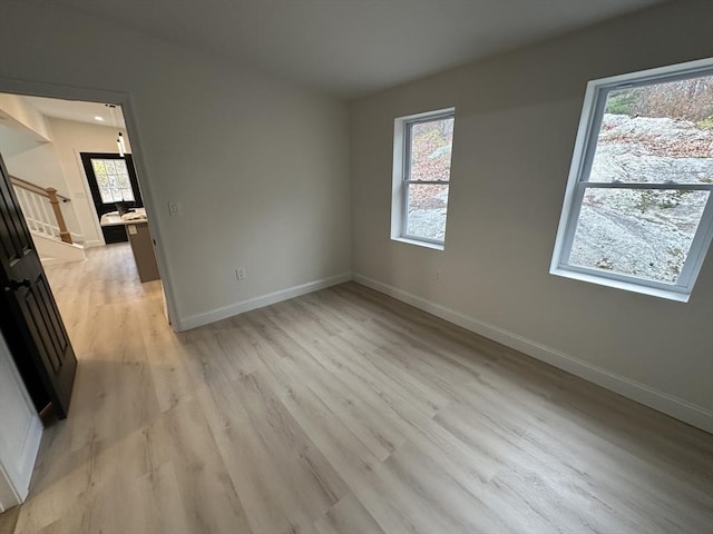 unfurnished room with light hardwood / wood-style flooring