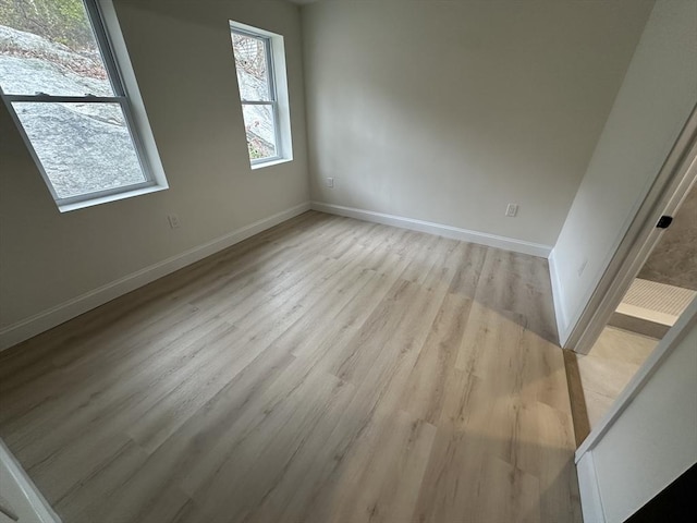 unfurnished room featuring light hardwood / wood-style floors