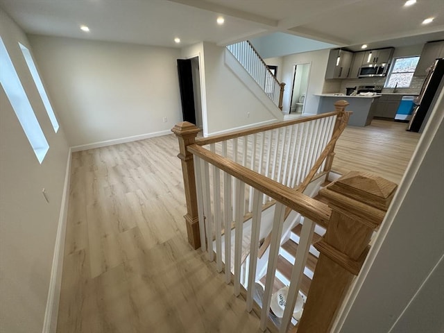 stairs featuring hardwood / wood-style flooring