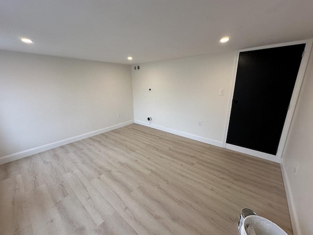 unfurnished room with light hardwood / wood-style floors