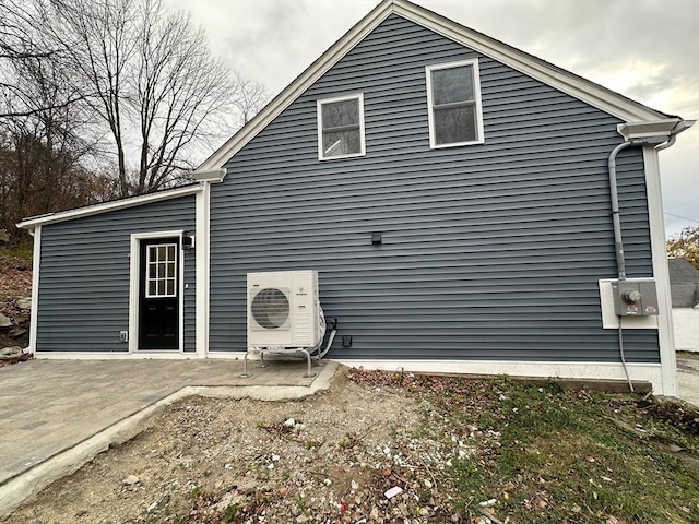 back of property featuring a patio and ac unit