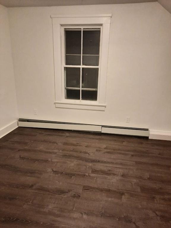 unfurnished room featuring a baseboard radiator and dark wood-type flooring