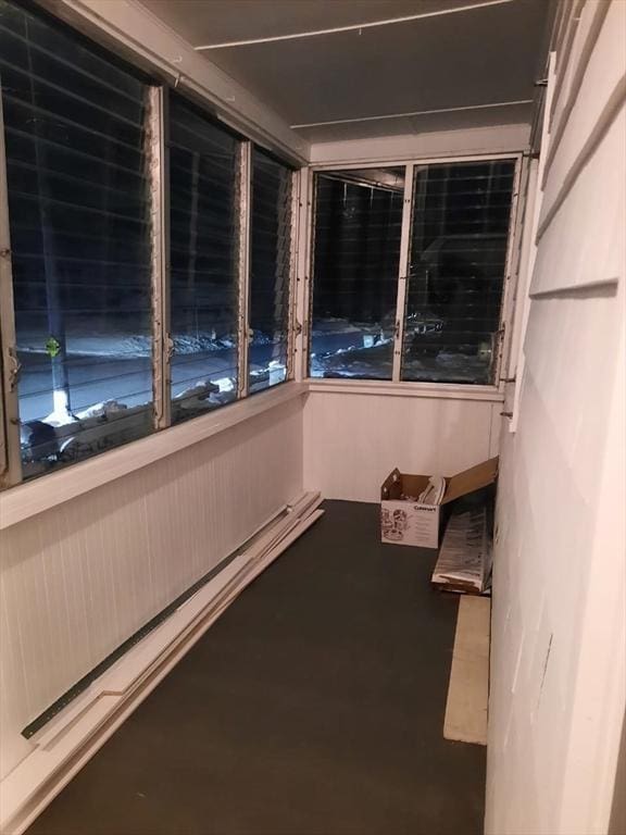 unfurnished sunroom featuring baseboard heating