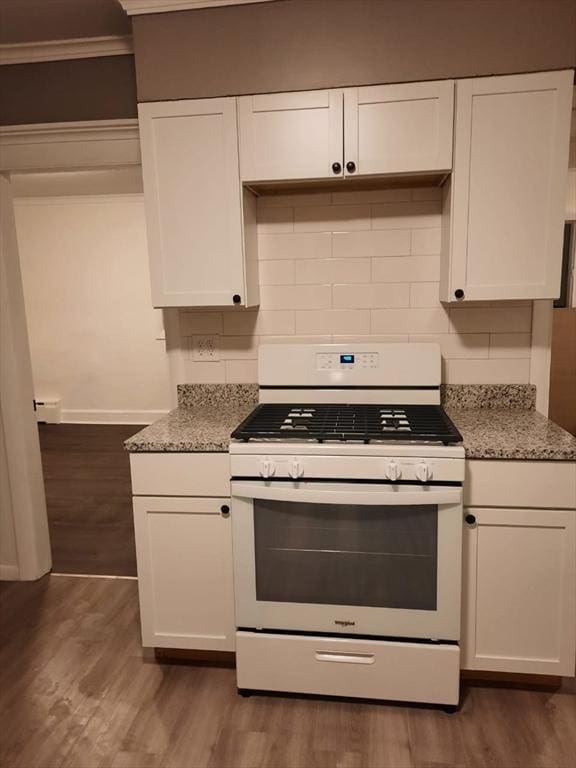 kitchen featuring white cabinetry, white gas stove, and stone counters