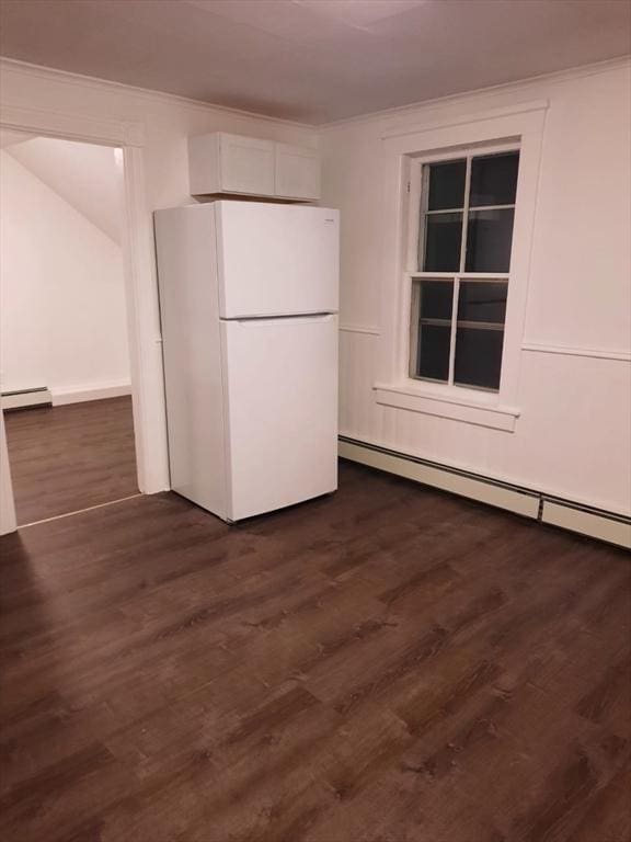 kitchen featuring baseboard heating, dark hardwood / wood-style floors, white fridge, and white cabinets