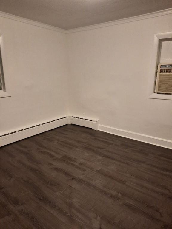 spare room with cooling unit, a baseboard radiator, ornamental molding, and dark hardwood / wood-style floors