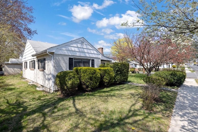 view of side of property featuring a yard