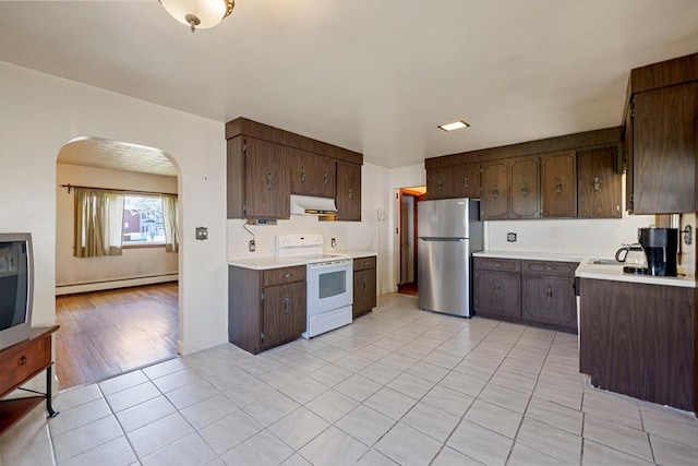 kitchen featuring white range with electric stovetop, baseboard heating, arched walkways, freestanding refrigerator, and under cabinet range hood
