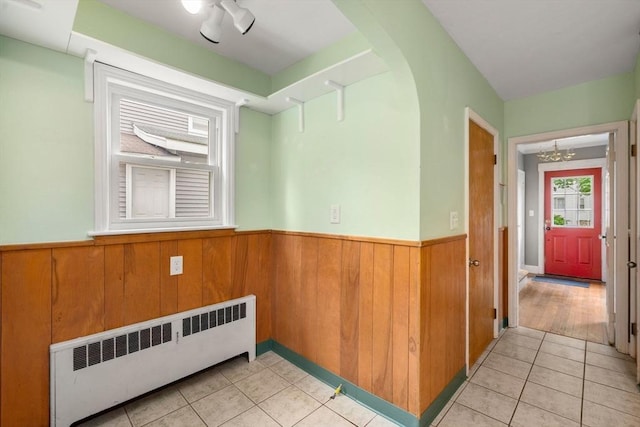 229 May St, Worcester, MA 01602 - empty room with radiator heating unit, a wainscoted wall, light tile patterned floors, a chandelier, and wooden walls