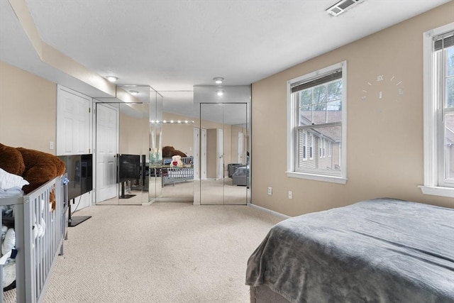 7 Hovey Pond Dr Unit 7, Grafton, MA 01536 - bedroom with light carpet, two closets, and baseboards