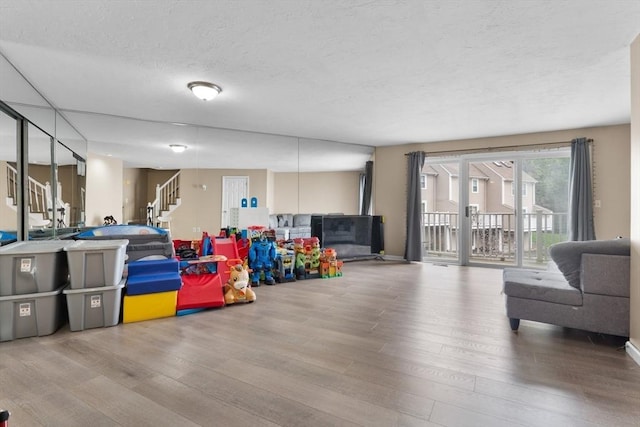 7 Hovey Pond Dr Unit 7, Grafton, MA 01536 - playroom featuring wood finished floors and a textured ceiling