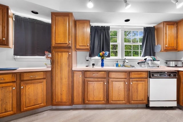 7 Hovey Pond Dr Unit 7, Grafton, MA 01536 - kitchen with white dishwasher, brown cabinets, and a sink